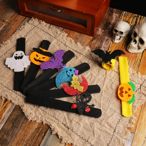 Variety of Halloween snap bracelets with pumpkin and bat designs on rustic wood background