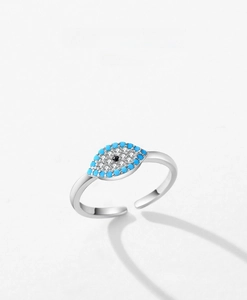 Detailed macro view of S925 silver evil eye ring with turquoise and white crystals