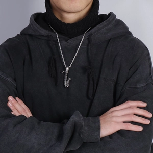 Silver saxophone pendant necklace with twisted rope chain worn by male model