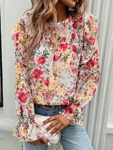 Detail of floral chiffon shirt featuring red roses and smocked neckline design