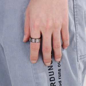 Macro view of 8mm hammered texture titanium steel ring for men on denim fabric