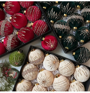 Detailed view of velvet Christmas ornaments with glitter patterns in a gift box
