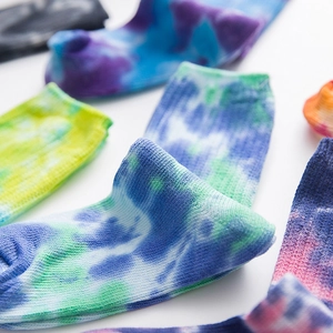 Unisex colorful tie-dye crew socks in various vibrant patterns and cotton knit textures