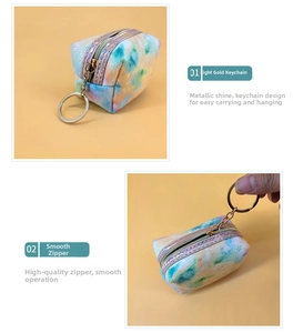 Detail of smooth metal zipper and light gold keychain on tie-dye star coin purse