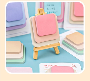 Colorful sticky notes set on a small wooden easel with a to-do list card on blue background