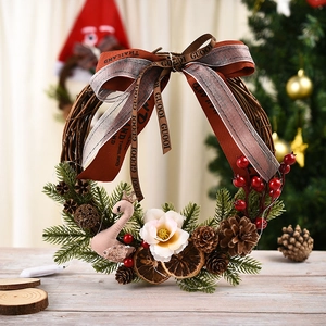 Illuminated Christmas wreath with pink swan and red berries on a rustic vine base