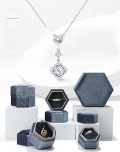 Macro detail of hexagonal velvet jewelry boxes in blue-grey with plush interior lining