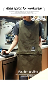 Detail of olive green work apron showing multi-purpose pockets in a cafe setting