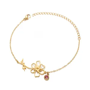 Detail of gold flower bracelet with pink birthstone and lobster clasp adjustment