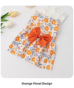 Detail of pet floral dress featuring a large orange silk bow and vibrant flower print