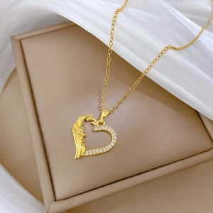 Close-up of golden heart pendant necklace with shimmering crystals on a jewelry box