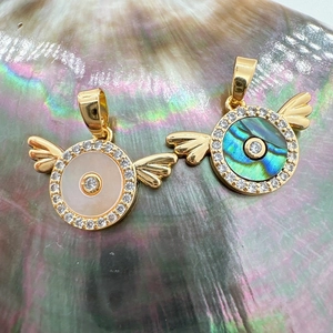 Close-up of 18K gold-plated wing charms with natural mother-of-pearl and abalone shell
