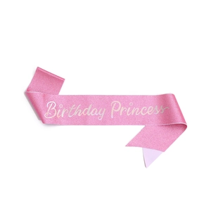 Detail of pink glitter Birthday Princess sash with elegant white cursive lettering