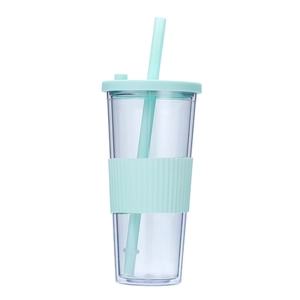 Close-up detail of the transparent double-wall plastic tumbler with mint green silicone sleeve and straw.