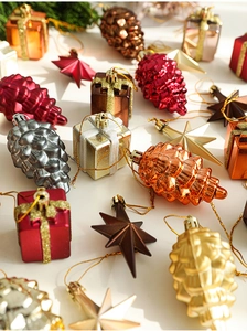 Close-up of assorted Nordic Christmas ornaments with metallic pinecones and gift boxes