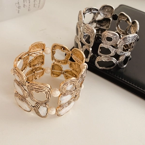 Detail of vintage geometric elastic bracelets with gold marble and silver black finishes
