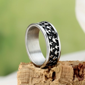 Vintage silver mushroom engraved stainless steel ring on a natural wood stand