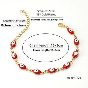 Détail d'un bracelet œil porte-bonheur rouge en acier inoxydable plaqué or 18 carats avec chaîne