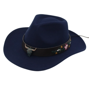 Détail d'un chapeau de cowboy bleu avec broderie florale et pendentif tête de taureau