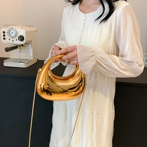 Elegant gold crescent cloud acrylic handbag with chain strap shown by a model