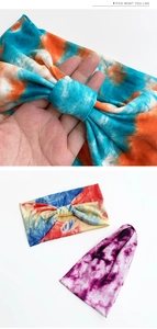 Close-up of wide tie-dye yoga headband showing elastic knit fabric and knotted detail