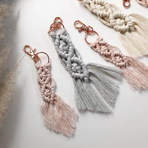 Detail of colorful macrame cotton rope keychains with rose gold lobster clasps and tassels