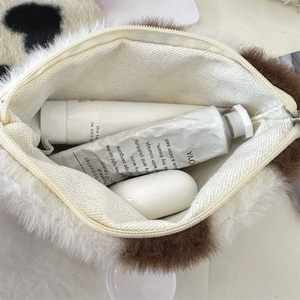 Detail view of the plush cosmetic bag interior showing storage capacity and soft texture