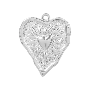 Macro shot of silver 304 stainless steel heart pendant with embossed leaf patterns