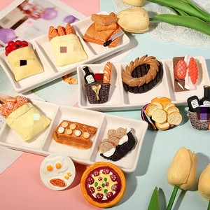 Detailed macro view of miniature resin food models on white plate with tulips