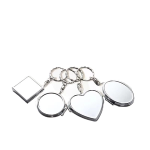 Set of four silver metal folding compact mirror keychains in various classic shapes
