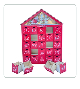 Detail of wooden Christmas advent calendar with 24 numbered drawers and LED house design