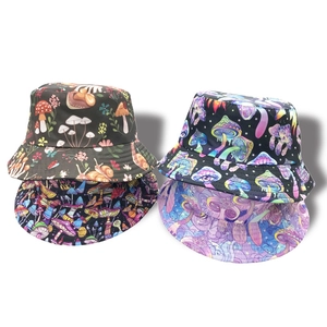 Detailed flat lay of fisherman hats featuring colorful hand-drawn mushroom prints on fabric