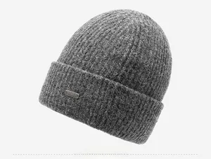 Detail of dark grey ribbed knit beanie showing the metallic logo and fabric texture