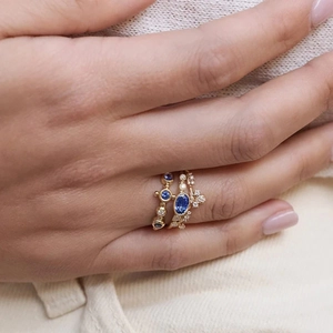 Detail of 925 sterling silver stacking rings featuring blue sapphire and zircon stones