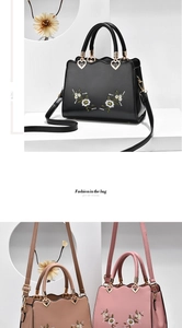 Close-up of floral embroidery on soft leather handbag with heart-shaped metal buckle