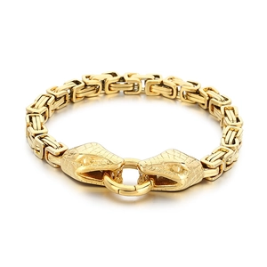 Golden titanium steel Byzantine chain bracelet with dual snake heads on white background