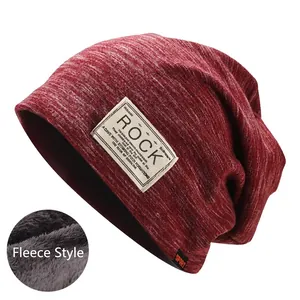 Detail view of burgundy knitted beanie with ROCK patch and warm fleece lining texture