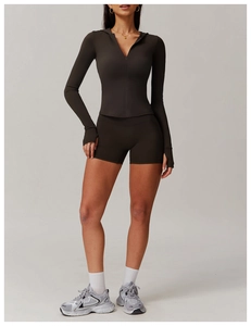 Detail of zippered hooded workout jacket with thumbholes and matching tight gym shorts