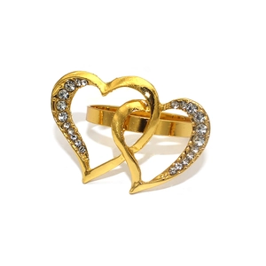 Close-up of interlocking heart napkin ring with sparkling rhinestones and gold finish