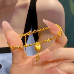 Detailed view of 24k gold plated beaded bracelet with fortune bag lucky charm