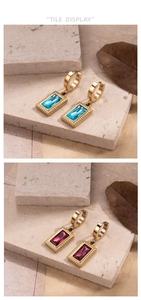 Detail of square zircon drop earrings in blue and rose colors with textured gold finish