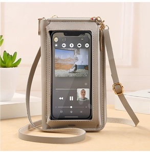 Detailed view of touch-screen window and adjustable strap on khaki faux leather bag