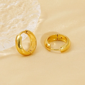 Minimalist 18K gold plated stainless steel hoop earrings on a light beige fabric background