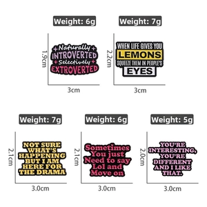 Detailed view of colorful enamel pins with English quotes and exact dimensions