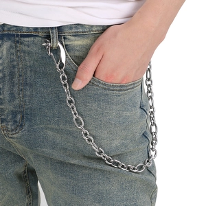 Detail shot of a silver metal skull pant chain hanging on denim jeans pocket