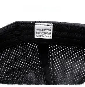 Close-up of the care label inside the black mesh cap showing 100% cotton material info