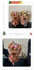 Detail of Christmas teddy bear plush flower bucket with festive scarf and pink roses