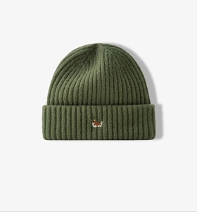 Detail of army green knitted beanie featuring a cute embroidered corgi puppy on front