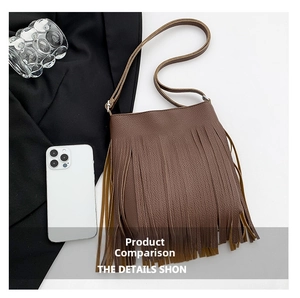 Detail view of brown tassel shoulder bag featuring lychee grain texture and metal buckle