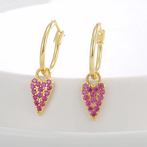 Elegant gold-plated heart drop earrings with shimmering pink zircon stones in a macro view